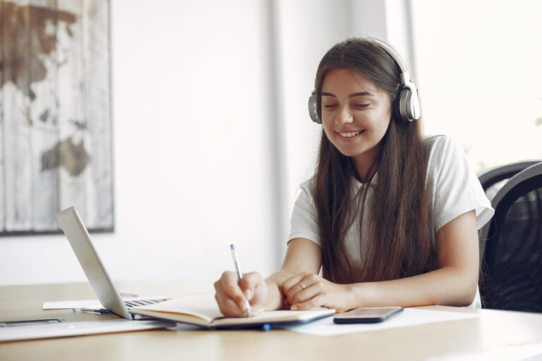 young student sitting table use laptop scaled
