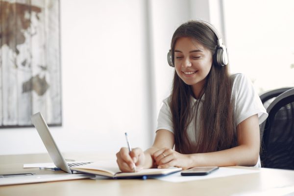 young student sitting table use laptop scaled